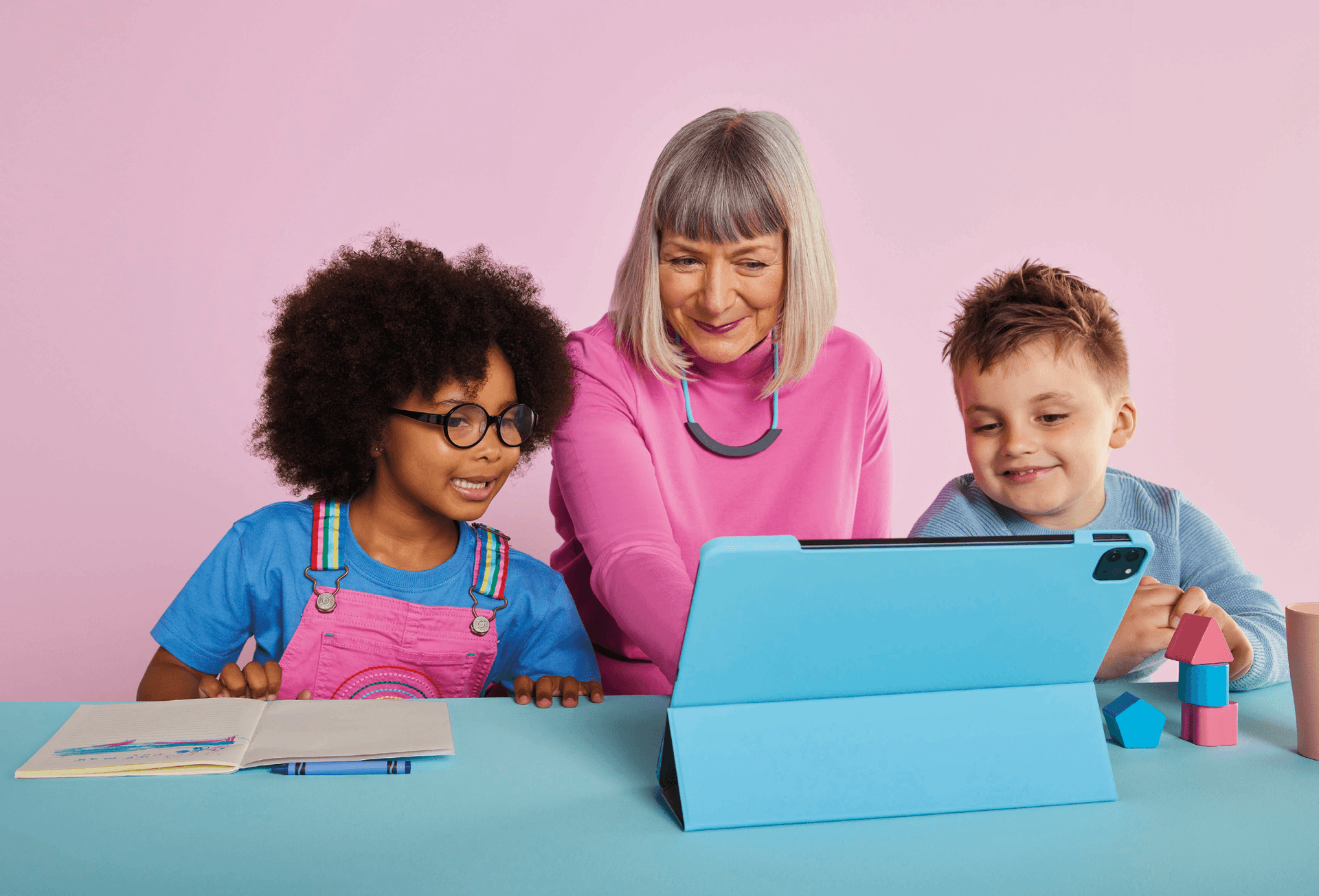 Woman on Hey Pharmacist on her tablet with children watching