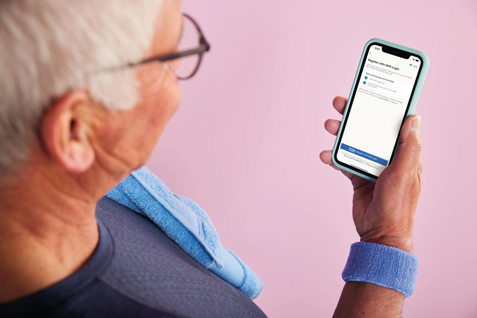 Man holding phone NHS Login 