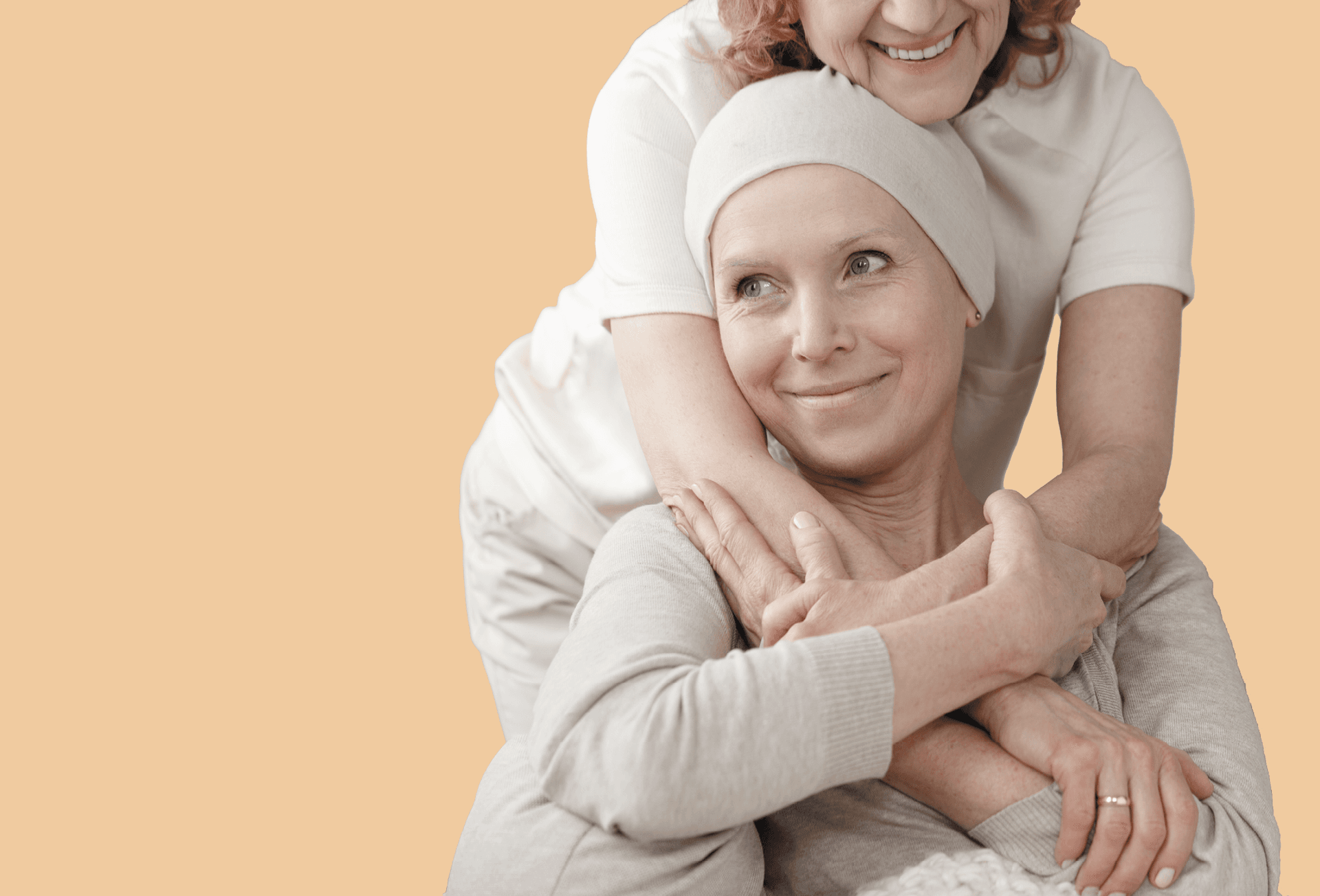 Woman on chemotherapy treatment being hugged and smiling