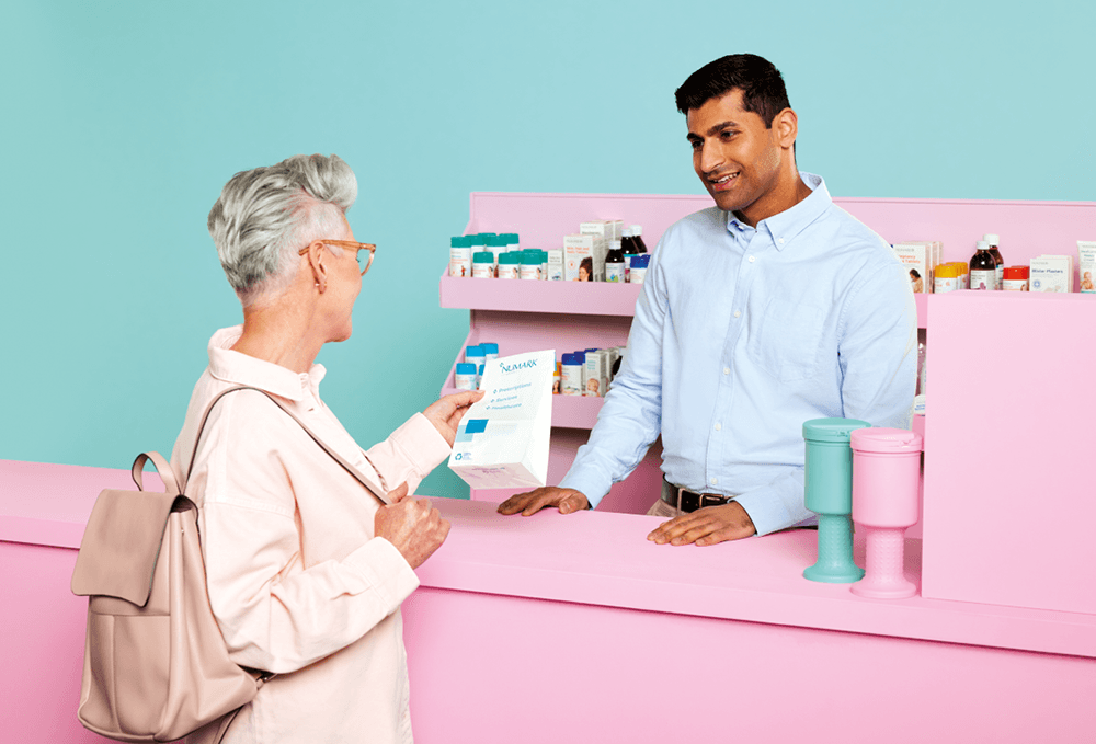 Woman collecting medication from pharmacy